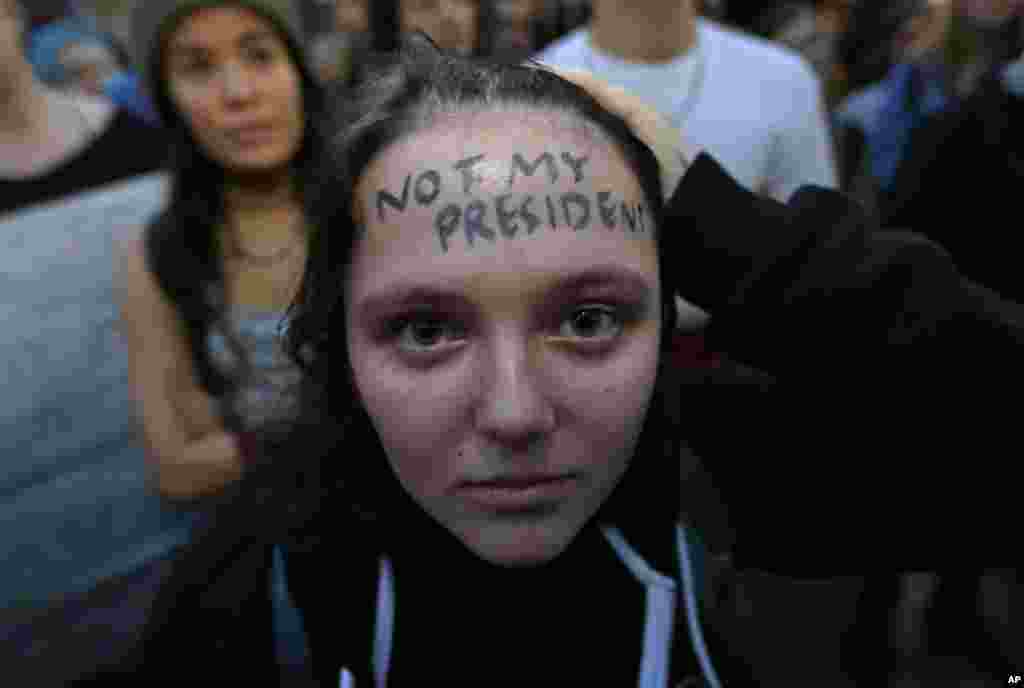 Clair Sheehan has the words "Not My President" written on her forehead as she takes part in a protest against the election of President-elect Donald Trump, Nov. 9, 2016, in downtown Seattle. 