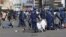 FILE: Riot police arrest and forcibly apprehend protestors during protests in Harare, Friday, Aug, 16, 2019. 
