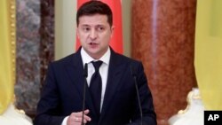 Ukrainian President Volodymyr Zelenskiy speaks during a joint news briefing with Polish President Andrzej Duda as they meet in Kyiv, Ukraine, Monday, Oct. 12, 2020. (Valentyn Ogirenko/Pool via AP)