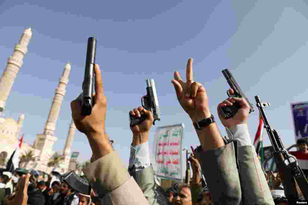 Protesters, predominantly Houthi supporters, raise their weapons as they demonstrate in solidarity with the Palestinians in the Gaza Strip, in Sanaa, Yemen.