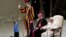 A child plays with a Swiss guard in the Paul VI Hall at the Vatican, Wednesday, Nov. 28, 2018. Pope Francis has praised the freedom, albeit undisciplined, of a hearing-impaired child who climbed onto the stage during his general audience to play.