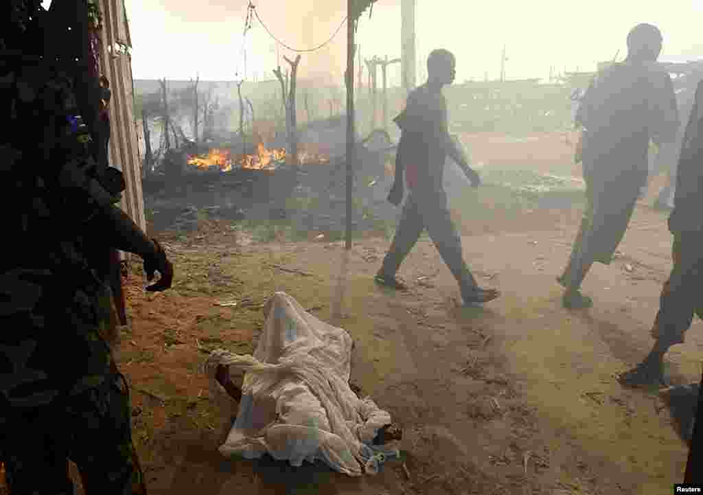 The burnt body of a boy killed during an air strike by the Sudanese air force is covered with sheets in a market in Rubkona near Bentiu, South Sudan, April 23, 2012. (Reuters)