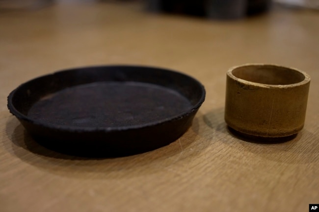 A plate and cup made from food cement are seen at the laboratory of Tokyo University in Tokyo on May 26, 2022. (AP Photo/Chisato Tanaka)