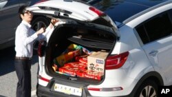 FILE - A South Korean vendor, his car filled with Choco Pie snacks and instant noodles, prepares to leave for the Kaesong Industrial Complex just north of the demilitarized zone separating the two Koreas, Sept. 16, 2013.