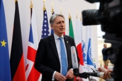 FILE - British Chancellor of the Exchequer Philip Hammond attends an interview during the G-7 finance ministers and central bank governors meeting in Chantilly, near Paris, France, July 18, 2019.