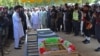 Security officials attend the funeral prayers for a policeman who was killed along with a polio worker in an attack by gunmen in Bajaur district, Khyber Pakhtunkhwa province, Pakistan, Sept. 11, 2024.