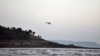 A helicopter on a search operation flies above the beach after more than a dozen college students were swept away at Murud on the Arabian Sea coast about 150 kilometers (95 miles) south of Mumbai, Maharashtra state, India, Monday, Feb. 1, 2016. Drowning is among the top five causes of death for children under 15 years in 48 of 85 countries surveyed.