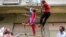 Garment workers from textile company Envoy Group demonstrate climbing a makeshift ladder, which serves as a fire exit to the building, during a protest in Dhaka, June 10, 2013. 