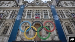 FILE: The Olympic rings are seen in front of the Paris City Hall, in Paris, Sunday, April 30, 2023. The 2024 Olympic Games will take place from July 26 to Aug.11, 2024 in Paris and other sites.