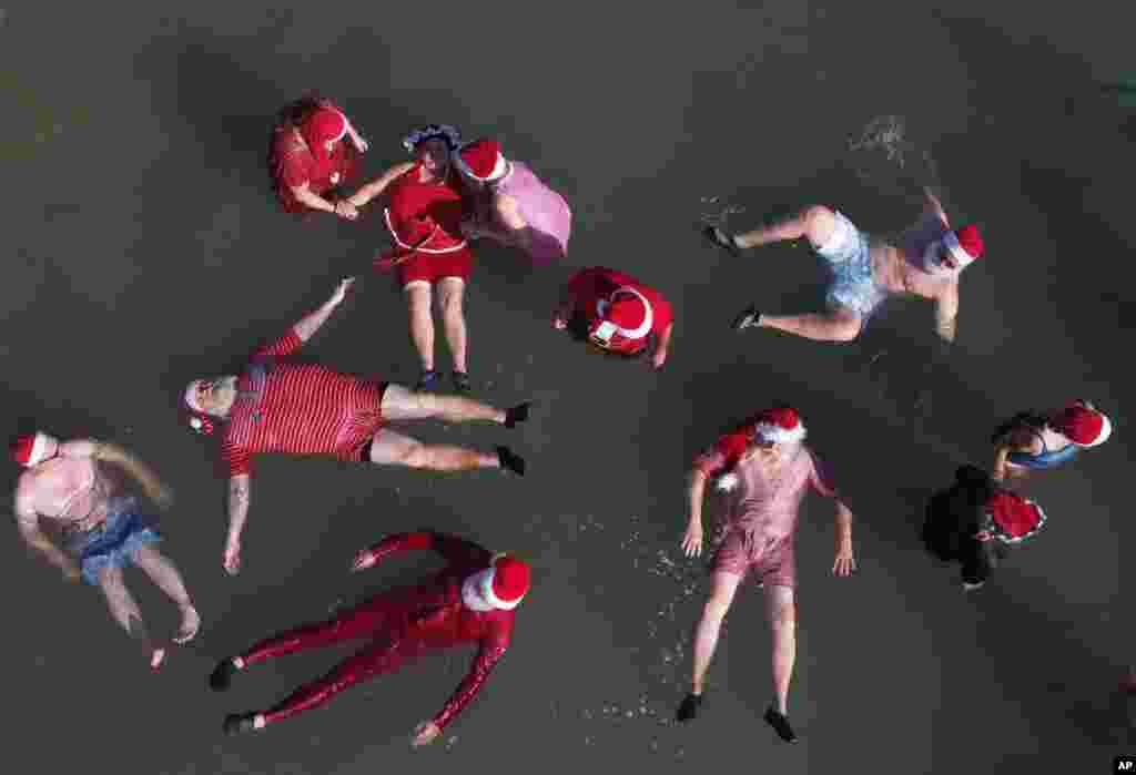 Members of a group of trained Santa Clauses from Europe and the USA float in the Dead Sea near the West Bank city of Jericho. Around 50 Santa Clauses and Miss Santas from the USA, Germany, Denmark and Romania visited the Holy land.