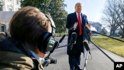 President Donald Trump speaks to the media as he leaves the White House,Feb. 23, 2020, in Washington, en route to India. 