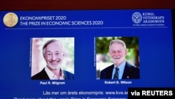 Pictures of the winners of the 2020 Nobel prize in economic sciences, Paul R. Milgrom and Robert B. Wilson, are displayed on a screen at a news conference in Stockholm, Sweden, Oct. 12, 2020. (TT News Agency/Anders Wiklund via Reuters)