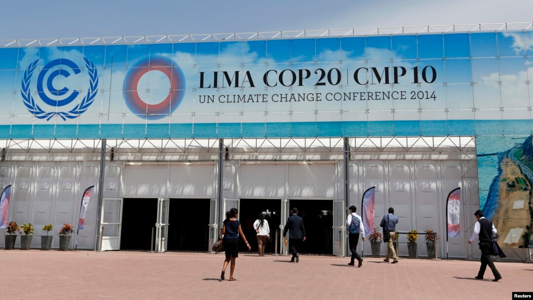 People walk at the venue of the U.N. Climate Change Conference COP 20 in Lima, Peru, Dec. 4, 2014.