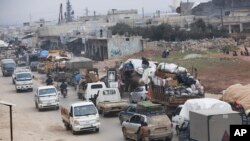 Syrian flee the advance of the government forces in the province of Idlib, Syria, towards the Turkish border, Jan. 29, 2020.