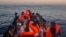 Refugees and migrants overcrowd a wooden boat during a rescue operation on the Mediterranean sea, about 19 miles north of Az Zawiyah, Libya on July 21, 2016.