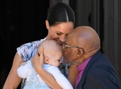 Britain's Prince Harry and Meghan, Duchess of Sussex, holding their son Archie, meet with Anglican Archbishop Emeritus, Desmond Tutu, in Cape Town, South Africa, Wednesday, Sept. 25, 2019.