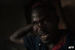 FILE—A pro-government militiaman shouts in a hospital in Kanyabayonga, southern Lubero territory, North Kivu province, eastern Democratic Republic of Congo, on May 4, 2024.