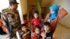 Civilians, who fled their homes due to the clashes on the outskirts of Falluja, gather in the town of Garma, Iraq, May 30, 2016. 