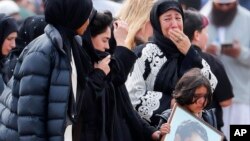 FILE - Mourners arrive for a burial service of a victim from the March 15 mosque shootings at the Memorial Park Cemetery in Christchurch, New Zealand, March 21, 2019. 