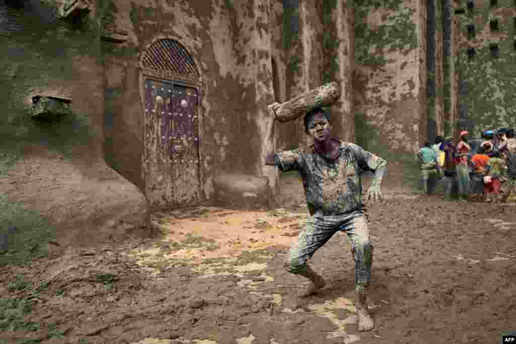 A man takes part in the annual rendering of the Great Mosque of Djenne in central Mali, April 28, 2019.