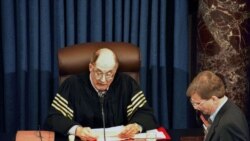 Supreme Court Chief Justice William Rehnquist reads the vote tally in the Senate's impeachment trial of President Clinton, as Clinton's attorney Charles Ruff (L) listens, February 12. The Senate rejected both counts, with neither charge receiving a…