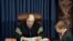Supreme Court Chief Justice William Rehnquist reads the vote tally in the Senate's impeachment trial of President Clinton, as Clinton's attorney Charles Ruff (L) listens, February 12. The Senate rejected both counts, with neither charge receiving a…