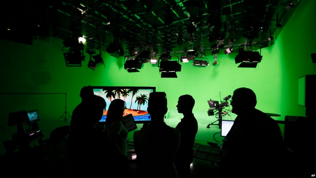 FILE - employees of the "Russia Today" television channel prepare for a visit by Russian President Vladimir Putin to Russia Today's new headquarters in Moscow, Russia. 