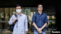 FILE - Chung Pui-kuen, former chief editor of the now-shuttered Stand News, and Patrick Lam, former acting chief editor, leave the District Court during the hearing on charges of conspiring to publish seditious publications, in Hong Kong, China, on June 27, 2023. 