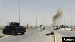 Smoke rises from a bomb attack in clashes between Iraqi security forces and Islamic State militants on the outskirts of Ramadi, April 9, 2015. 