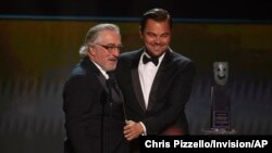 Leonardo DiCaprio, right, presents the lifetime achievement award to Robert De Niro at the 26th annual Screen Actors Guild Awards at the Shrine Auditorium & Expo Hall, Jan. 19, 2020, in Los Angeles. 