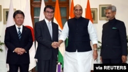 India's Defense Minister Rajnath Singh (2-R) shakes hands with his Japanese counterpart Taro Kono as India's Foreign Minister Subrahmanyam Jaishankar and Japan's Foreign Minister Toshimitsu Motegi look on, in New Delhi, India, Nov. 30, 2019.