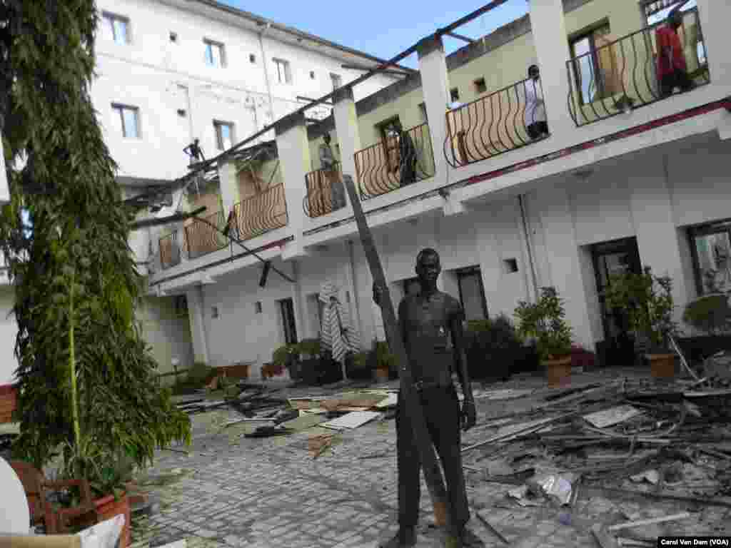 A worker helps to clear charred rubble from the South Sudan Hotel, which was heavily damaged by a fire on Oct. 2, 2013.