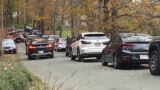 Cars line a narrow road outside a private property in an undated photo, in Pomfret, Vt., that has become a destination for fall foliage viewers, clogging the rural road. (AP Photo)