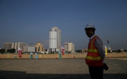 FILE - A Chinese construction worker stands at the Colombo Port City in Colombo, Sri Lanka, Jan. 2, 2018. President Maithripala Sirisena's government had criticized the previous administration for leading the country into a Chinese debt trap.