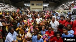 Pope Francis poses for a photo during a meeting with children of the Street Ministry and Callan Services at Caritas Technical Secondary School, in Port Moresby, Papua New Guinea, Sept. 7, 2024. Vatican Media/­Handout via REUTERS