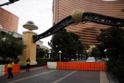 Barricades block the entrance to the Wynn hotel-casino after casinos were ordered to shut down along the Las Vegas Strip because of the coronavirus, March 18, 2020, in Las Vegas.