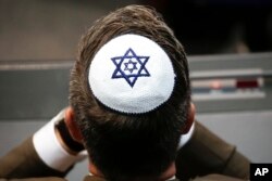 FILE —A member of the Christian Union party's faction wears a Jewish skullcap, or kippa, during a debate at the German parliament, about the 70th anniversary of the founding of the state Israel, in Berlin, April 26, 2018.