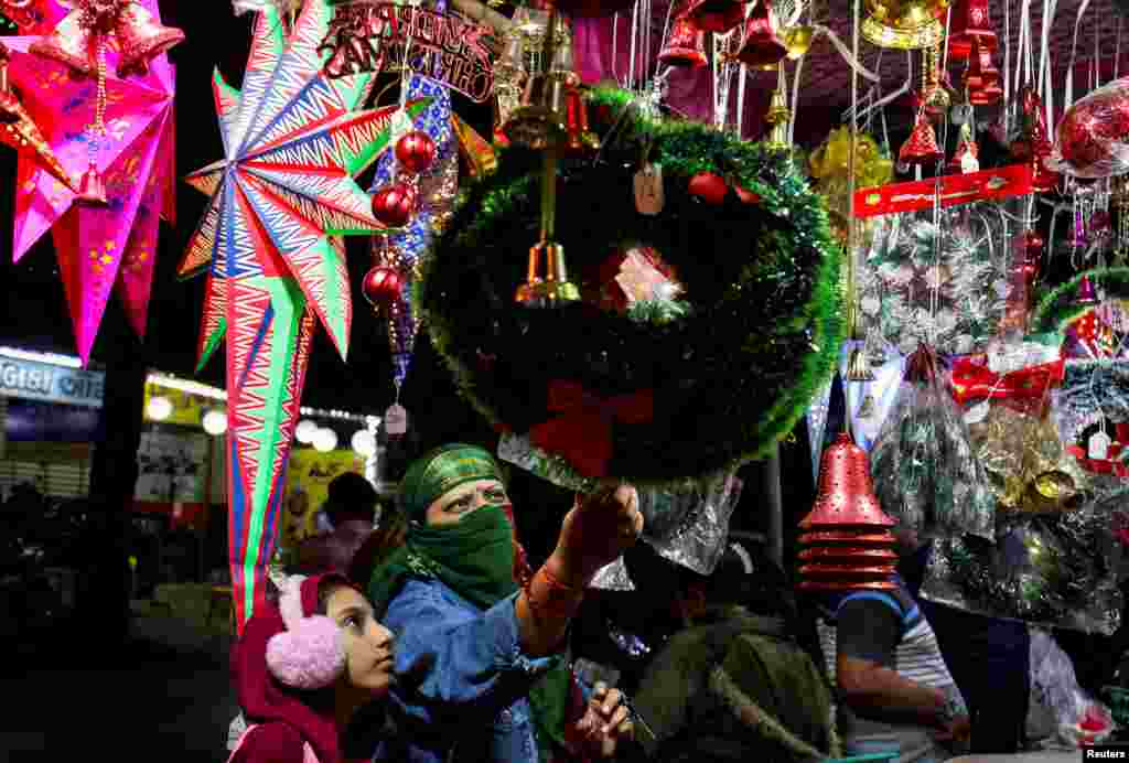 Women shop for Christmas decorations at a roadside market in Ahmedabad, India, Dec. 24, 2024.