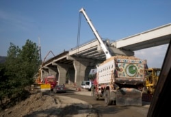 FILE - Work is in progress at a new international trade route near Havalian in Pakistan, May 11, 2017, as part of China's "Belt and Road Initiative."