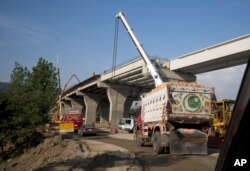 FILE - Work is in progress at a new international trade route near Havalian in Pakistan, May 11, 2017, as part of China's 'Belt and Road Initiative.'