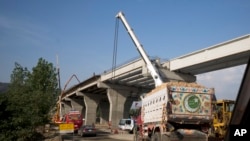 FILE - Work is pictured at an international trade route near Havalian in Pakistan, May 11, 2017, as part of China's Belt and Road Initiative.