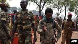 A member of the Central African Armed Forces (FACA) puts his knife away after taking part in the lynching of a man suspected of being a former Seleka rebel on Feb. 5, 2014, in Bangui. 