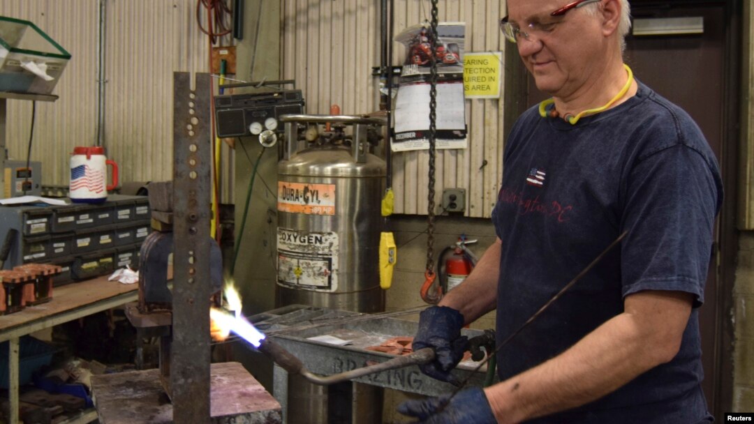 Mark Hoedee, a worker at transformer manufacturer RoMan Manufacturing welds a secondary coil for a transformer at the company's factory in Grand Rapids, Michigan, Dec. 7, 2016. 