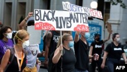 Demonstrators march near the White House to protest police brutality and racism, on June 10, 2020 in Washington, D.C.