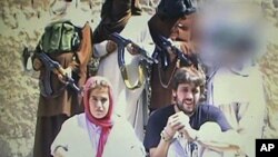 This image shows what is believed to be a Swiss couple, abducted by the Pakistani Taliban in Baluchistan, Pakistan, in July this year, taken from a militant video that emerged October 25, 2011.