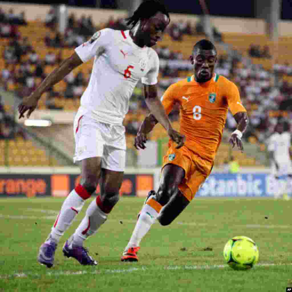 Kone of Burkina Faso fights for the ball with Kalou of Ivory Coast during their African Nations Cup soccer match in Malabo