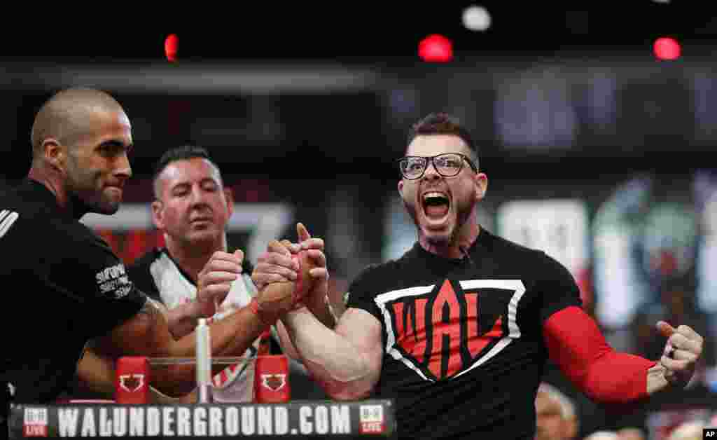 Geoff Hale, right, of Tulsa, Oklahoma, celebrates his win over Tom Holland, of Slough, Berkshire, United Kingdom, in the lightweight battle royale at the World Armwrestling League Championships in Atlanta, Georgia, USA, Sept. 5, 2018.