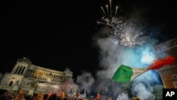 Italy's fans celebrate in Rome, Monday, July 12, 2021, after Italy beat England to win the Euro 2020 soccer championships in a final played at Wembley stadium in London.