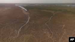 This aerial photo shows a general view of the Chibaish marshes during low water levels in Nasiriyah of southern Iraq on June 16, 2022. (AP Photo/ Nabil al-Jurani)