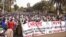 Women hold banners urging national talks to end the political paralysis in the south of Mali, in the capital Bamako, January 10, 2013.